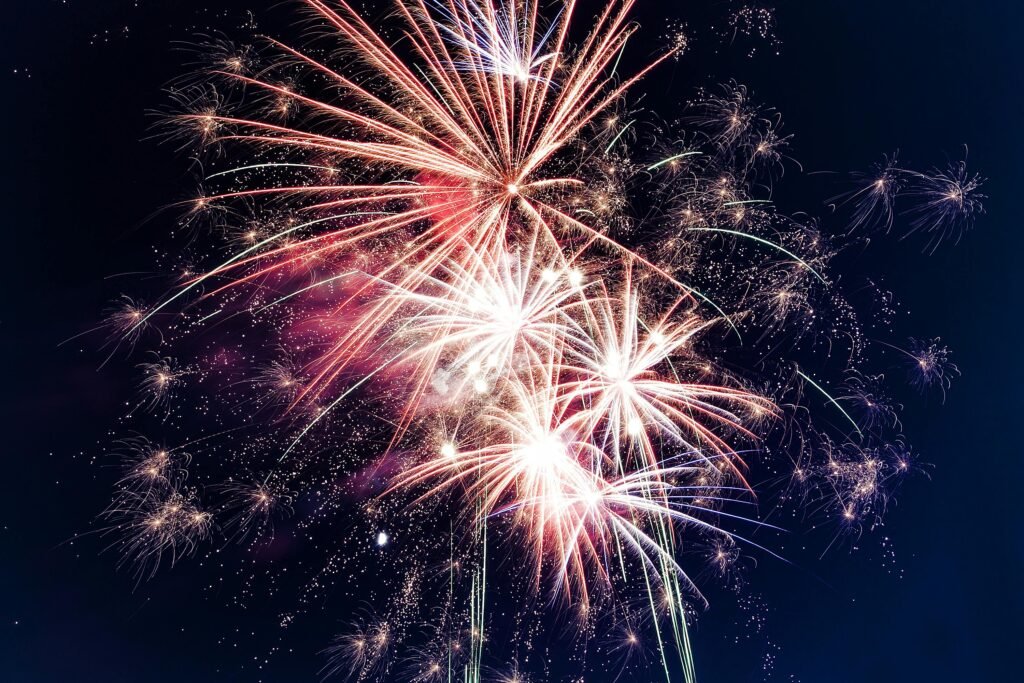 Colorful fireworks exploding in the night sky creating a festive atmosphere.