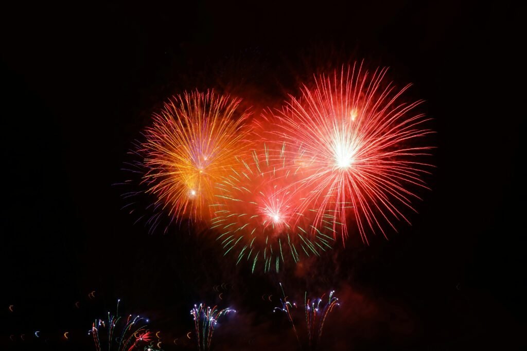 Colorful fireworks explode in the night sky, celebrating an event or festival.